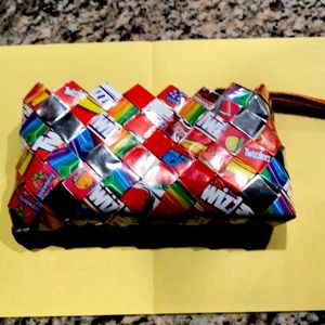 Small purse with candy wrappers on it.